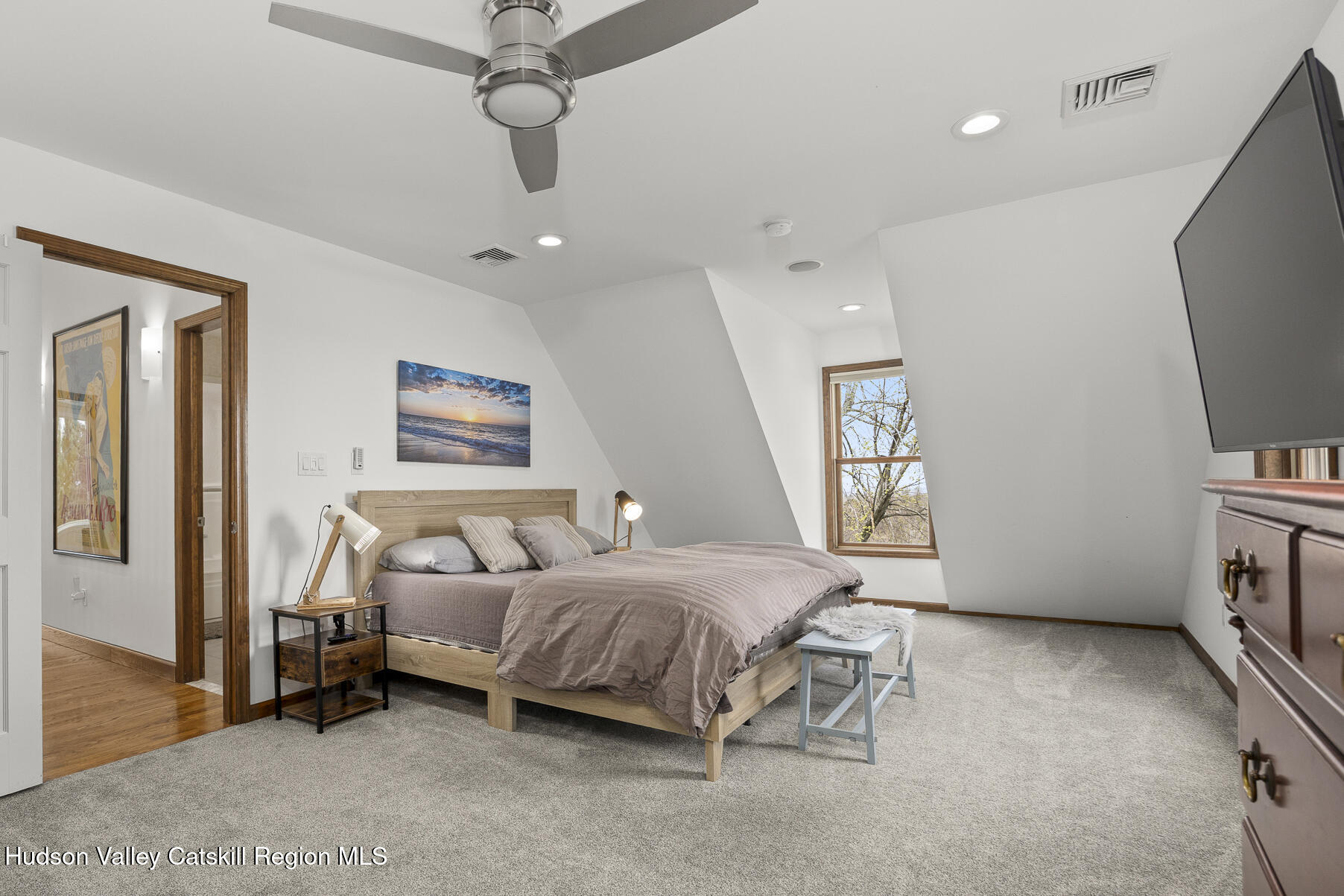 350 Taghkanic Road Elizaville, NY 12523 - Photo 25 of 36 a bedroom with a bed a couch and a flat tv screen on the dresser