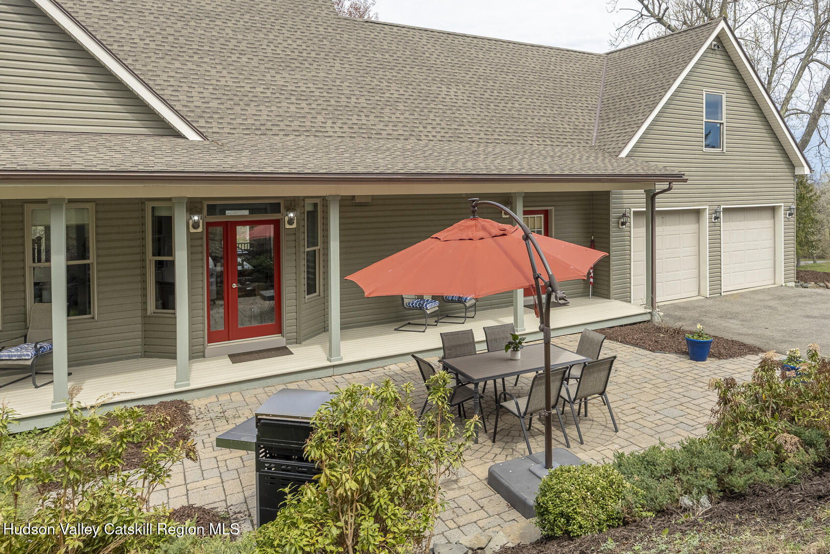 350 Taghkanic Road Elizaville, NY 12523 - Photo 34 of 36 a patio with a table and chairs under an umbrella