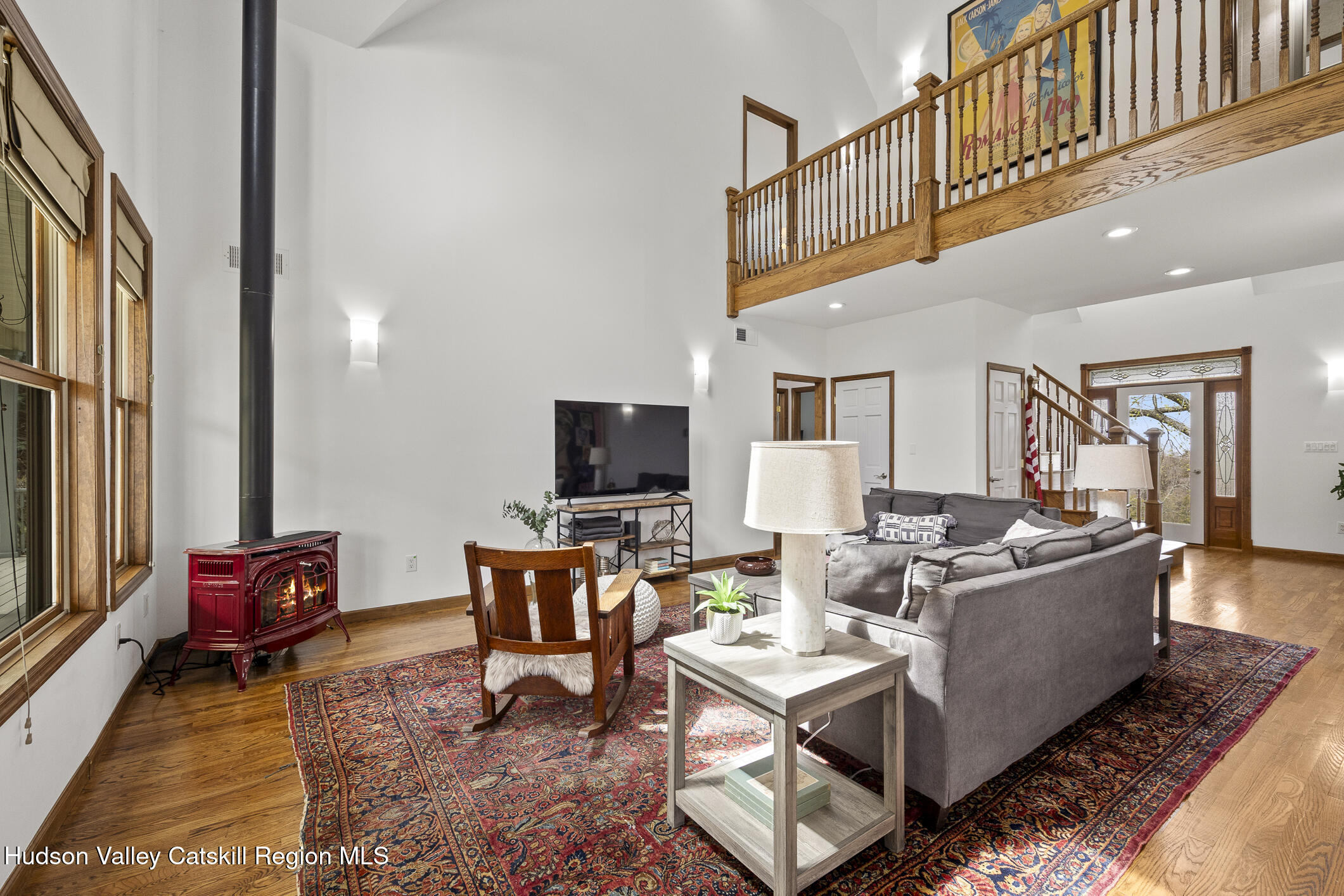 350 Taghkanic Road Elizaville, NY 12523 - Photo 10 of 36 a living room with furniture a flat screen tv and a floor to ceiling window