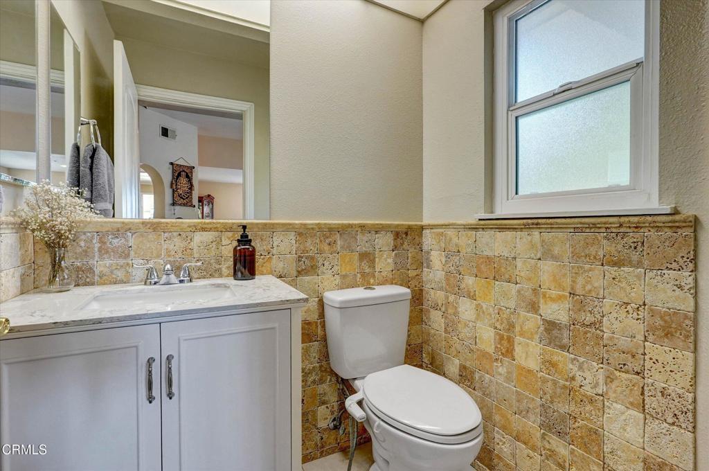 12477 Rajah Street Los Angeles, CA 91342 - Photo 14 of 34 a bathroom with a sink a toilet and a mirror