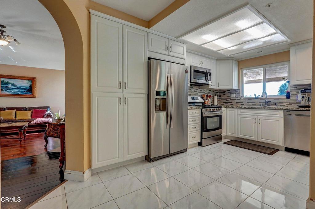 12477 Rajah Street Los Angeles, CA 91342 - Photo 15 of 34 a kitchen with stainless steel appliances granite countertop a refrigerator and a stove top oven
