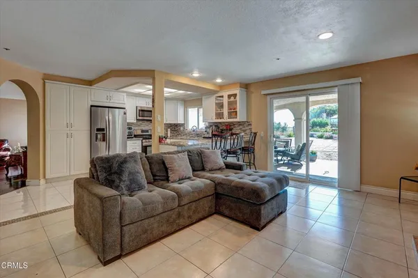 a kitchen with stainless steel appliances granite countertop a stove refrigerator and cabinets