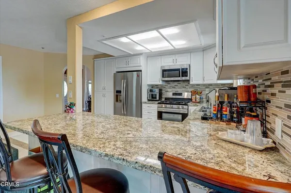 a living room with furniture and kitchen view