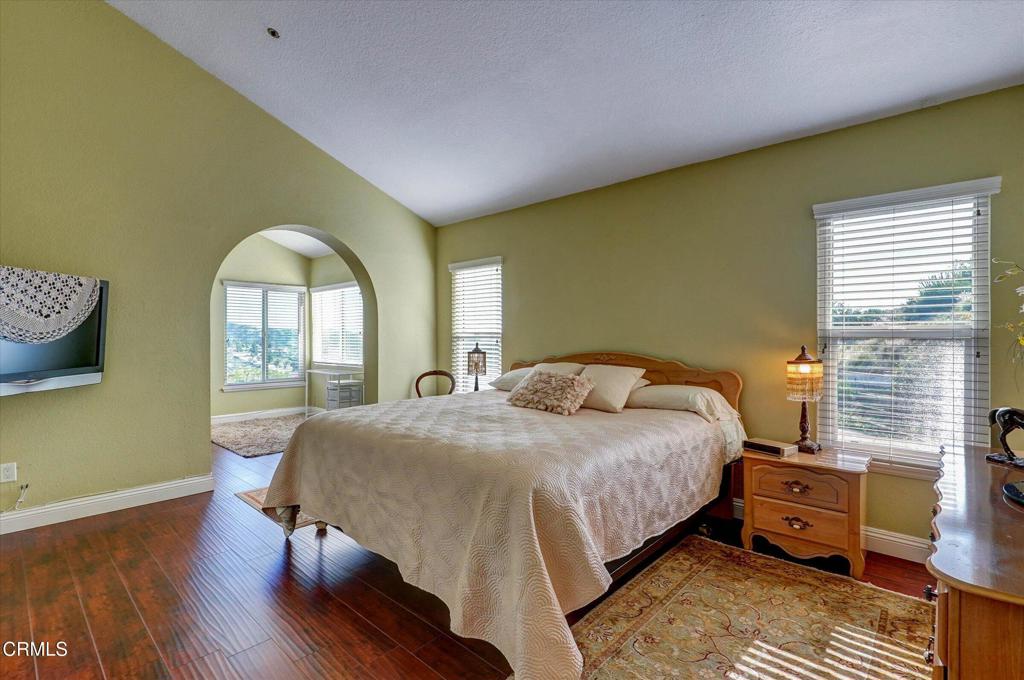 12477 Rajah Street Los Angeles, CA 91342 - Photo 21 of 34 a bedroom with a bed and wooden floor