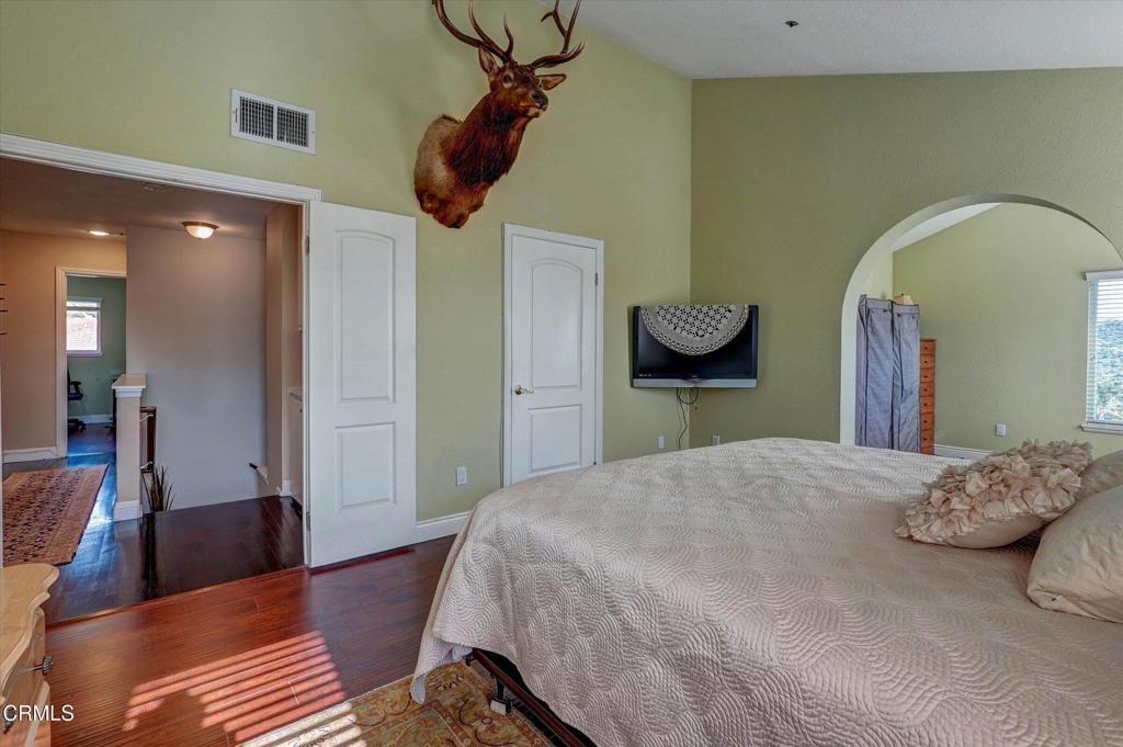 12477 Rajah Street Los Angeles, CA 91342 - Photo 24 of 34 a bedroom with a bed and a chandelier