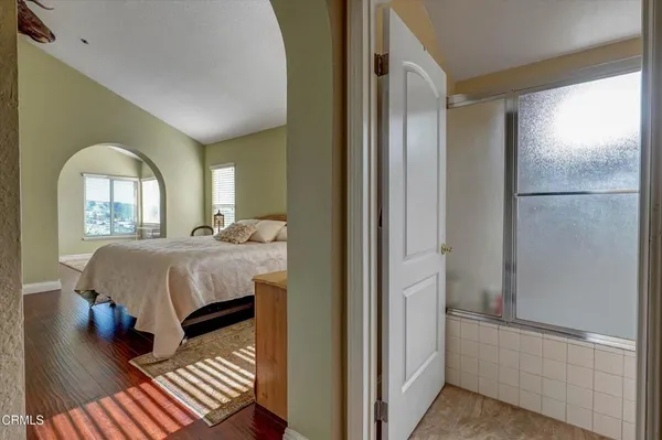 a bathroom with a granite countertop sink a toilet and a shower