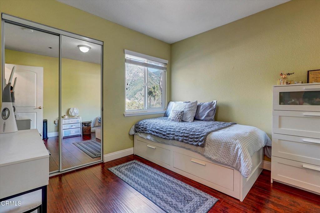 12477 Rajah Street Los Angeles, CA 91342 - Photo 29 of 34 a bedroom with a bed and wooden floor