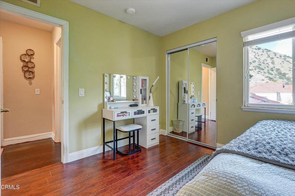 12477 Rajah Street Los Angeles, CA 91342 - Photo 30 of 34 a bedroom with a bed and a table in it