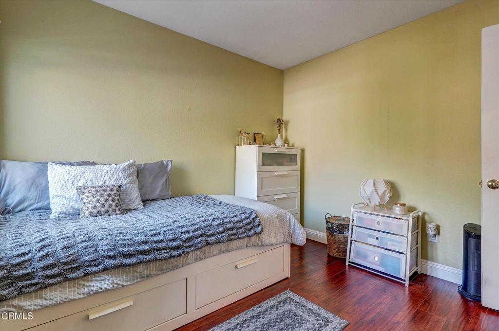 12477 Rajah Street Los Angeles, CA 91342 - Photo 31 of 34 a bedroom with a bed and wooden floor