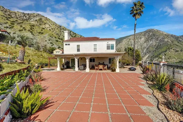 a front view of a building with a garden