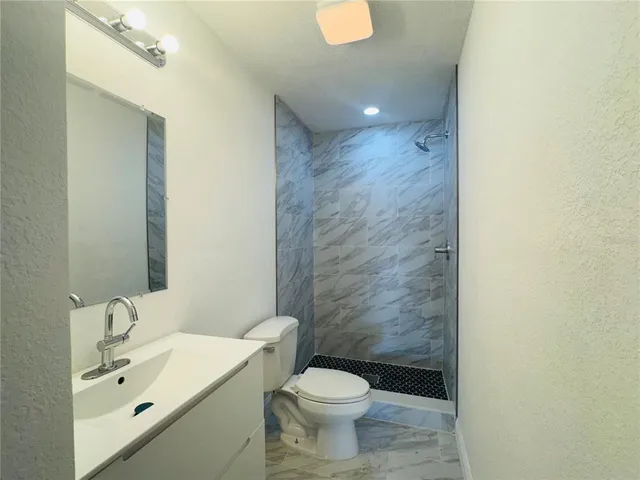 a view of a small space with wooden floor and a window