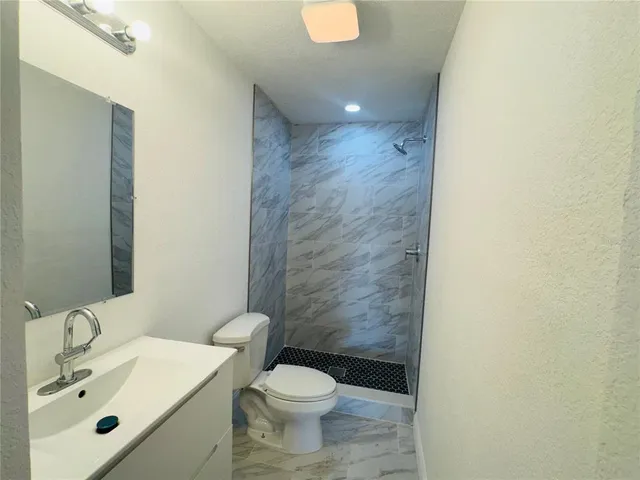 a living room with furniture and a air conditioner vent