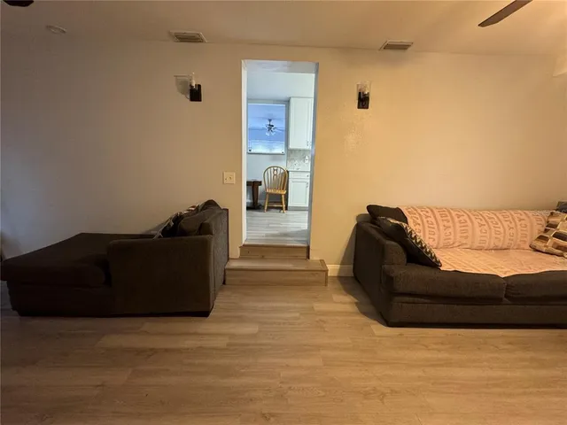 a view of a room with wooden floor and windows