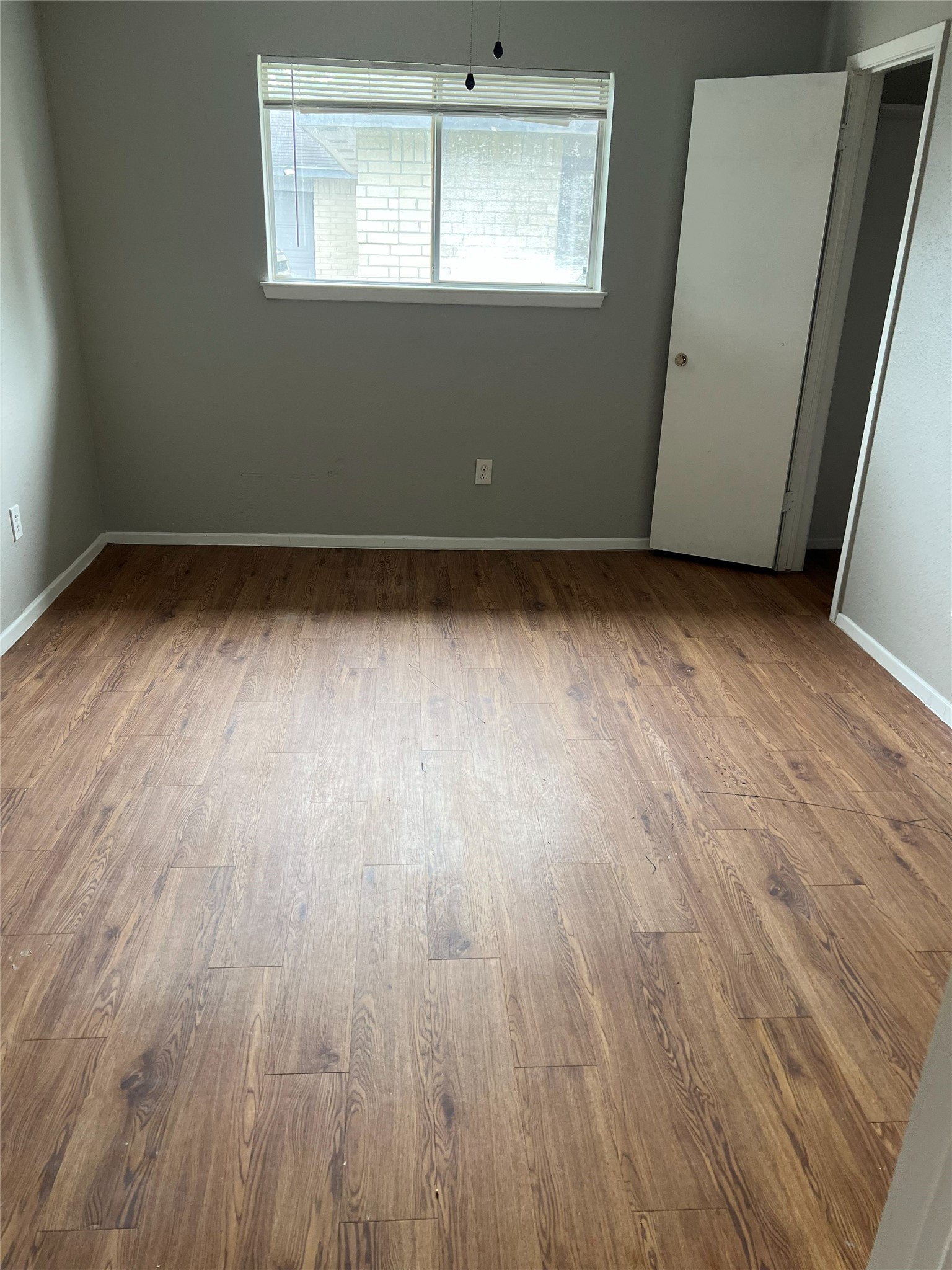 6507 Bridgegate Drive Spring, TX 77373 - Photo 11 of 17 an empty room with wooden floor and windows