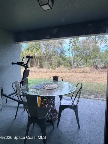 a view of a dining room with furniture and window