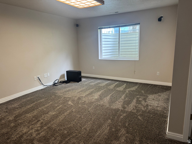 88 Canterbury Lane Logan, UT 84321 - Photo 24 of 37 Spacious room featuring patterned carpeting, neutral wall paint, and a large window with blinds