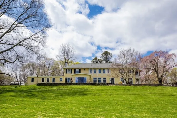 a view of a big yard with a house in the background