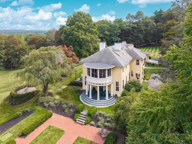 an aerial view of a house with a yard