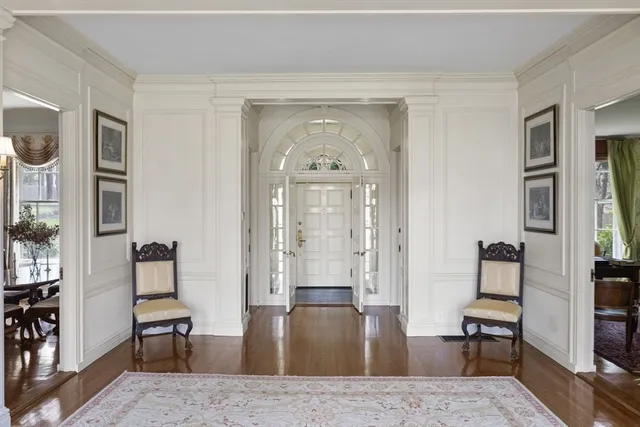 a view of entryway and hall with wooden floor