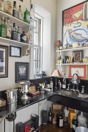 a kitchen with lots of bottles of alcohol
