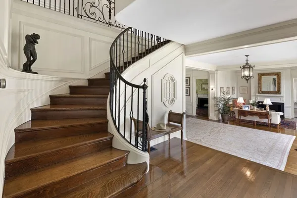a view of entryway and hall with wooden floor