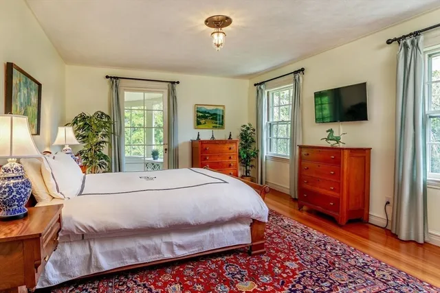 a bedroom with a bed and chair