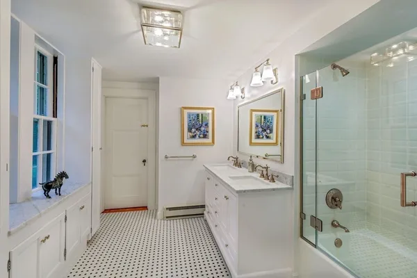 a bathroom with a sink a tub and a mirror