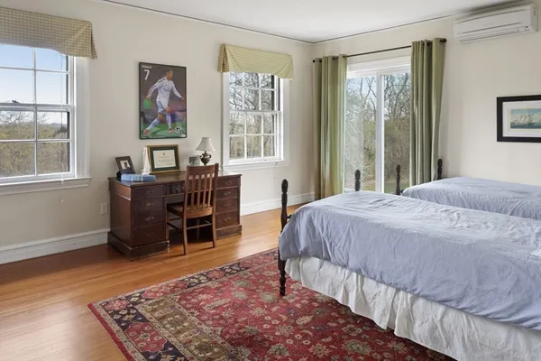 a bed sitting in a bedroom next to a window