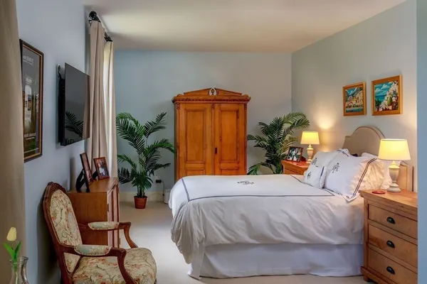 a bedroom with a bed and chair