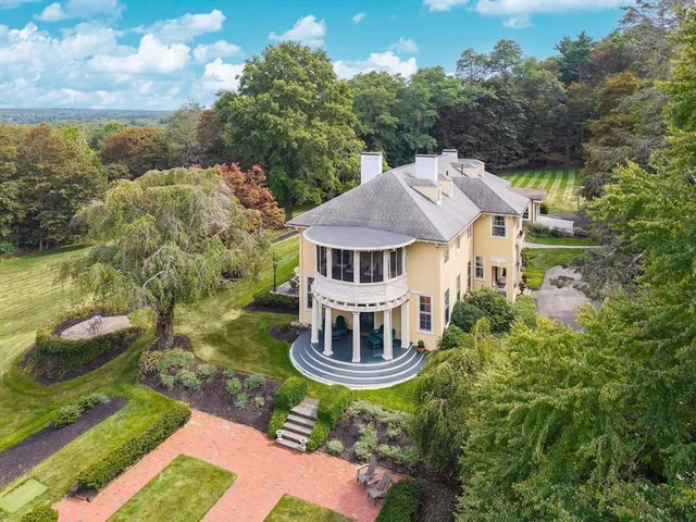 an aerial view of a house with a yard