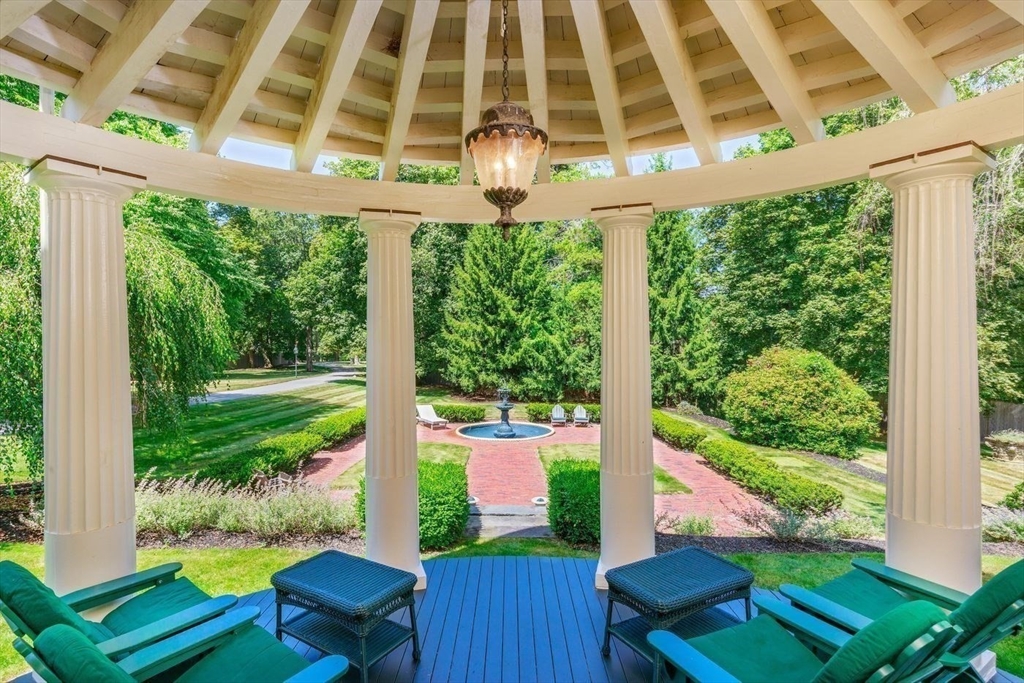 5 Main Drive Wenham, MA 01984 - Photo 9 of 37 a front view of a house with a yard balcony and outdoor seating