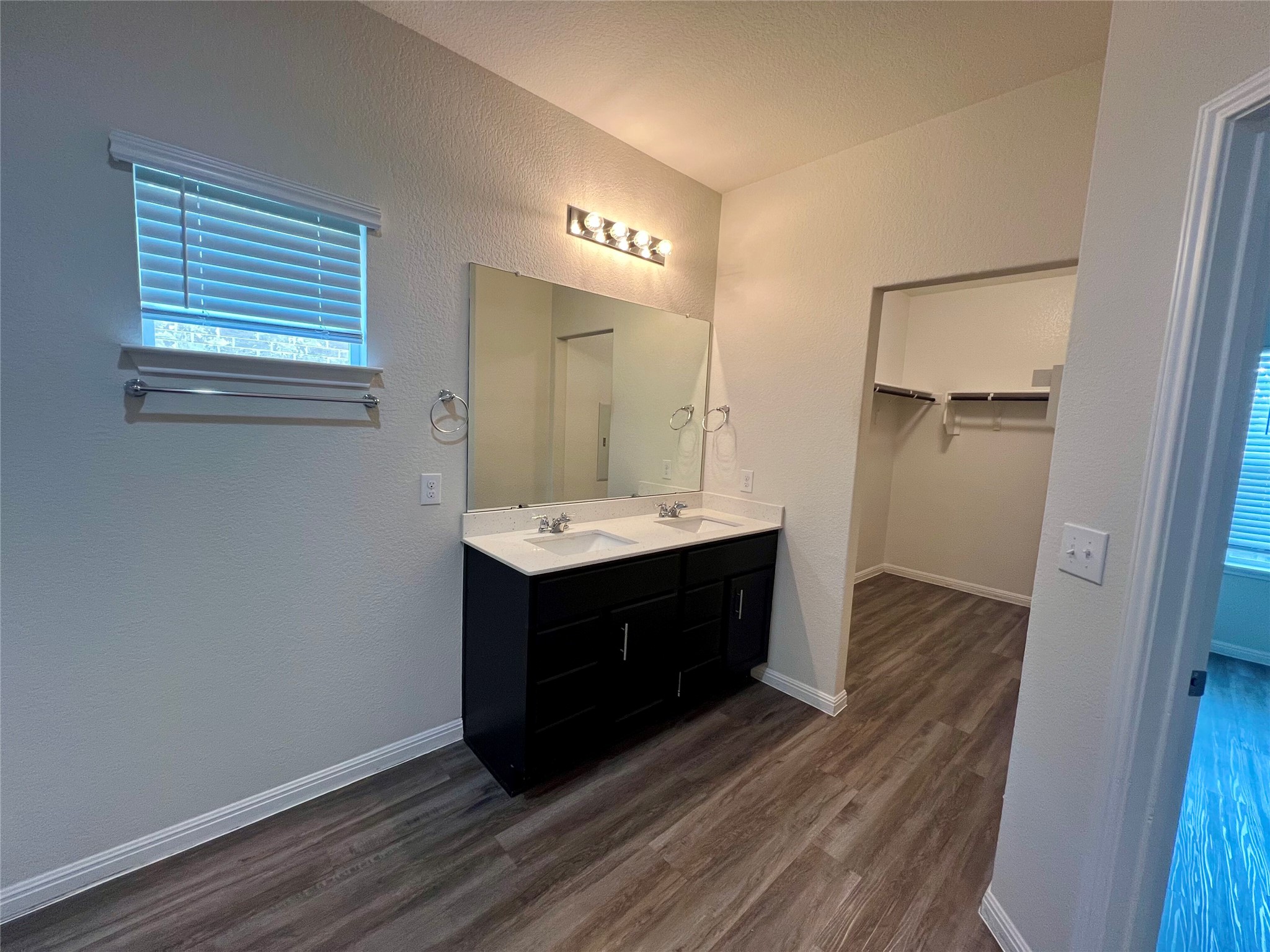 104 Moravia Road Georgetown, TX 78626 - Photo 22 of 36 Double vanity sinks and a spacious walk-in closet enhance this well-appointed primary bathroom.