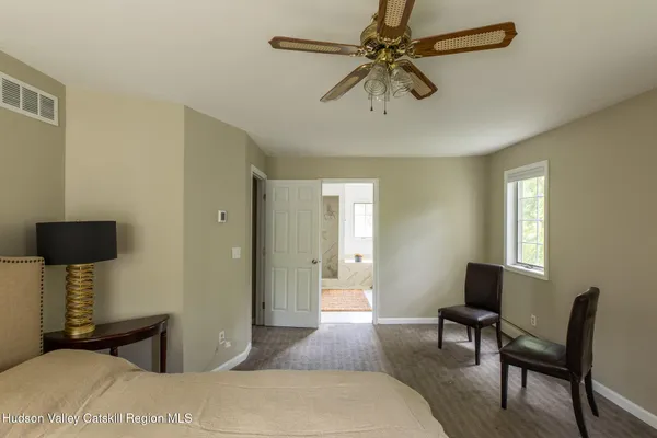 a bedroom with furniture and a window
