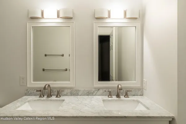 a bathroom with a sink vanity and a mirror