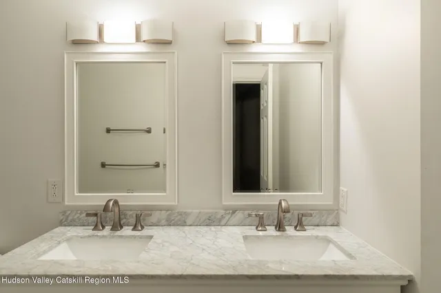 a bathroom with a sink vanity and a mirror