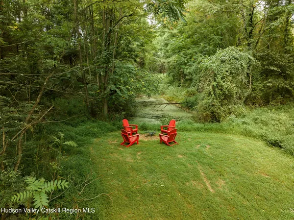 a view of a wooden floor and some trees in the background