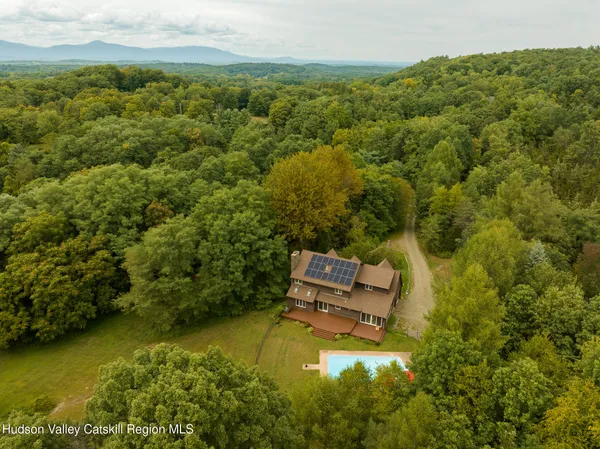 an aerial view of a house with a yard