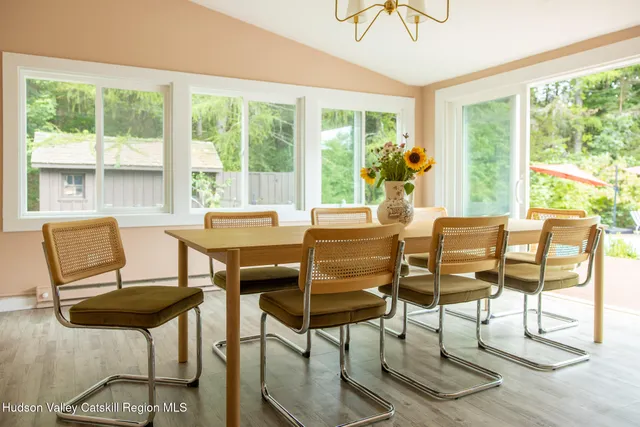 a dining room with furniture a chandelier and wooden floor