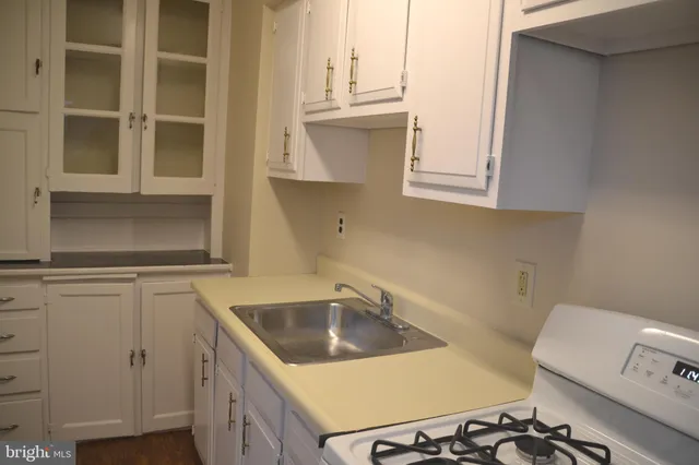 a kitchen with granite countertop a sink and a stove