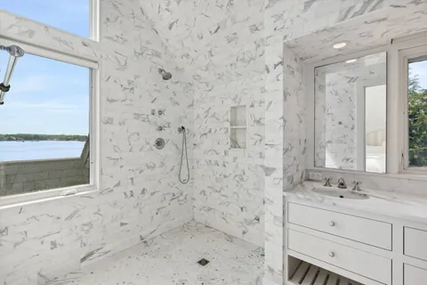 a bathroom with a sink a vanity and a shower