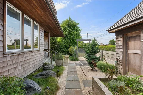 a view of a pathway both side of house