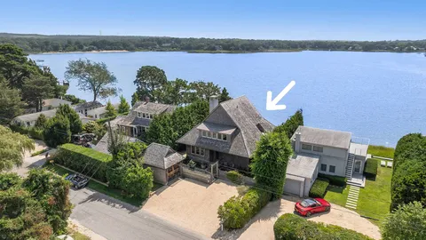an aerial view of a house with outdoor space and lake view