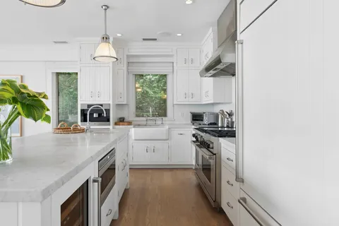 a kitchen with a sink stove and cabinets