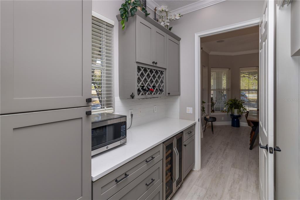 3305 Schoolhouse Road St. Cloud, FL 34773 - Photo 22 of 83 a kitchen with a refrigerator and a stove top oven