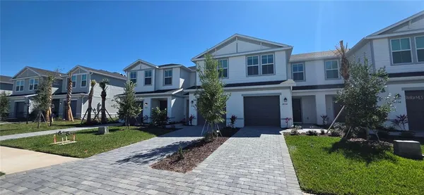 a front view of a house with a yard and porch