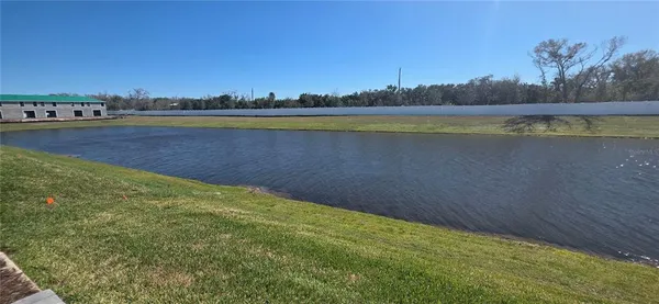 a view of a lake with houses in the back