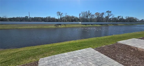 a view of a lake with houses in the back