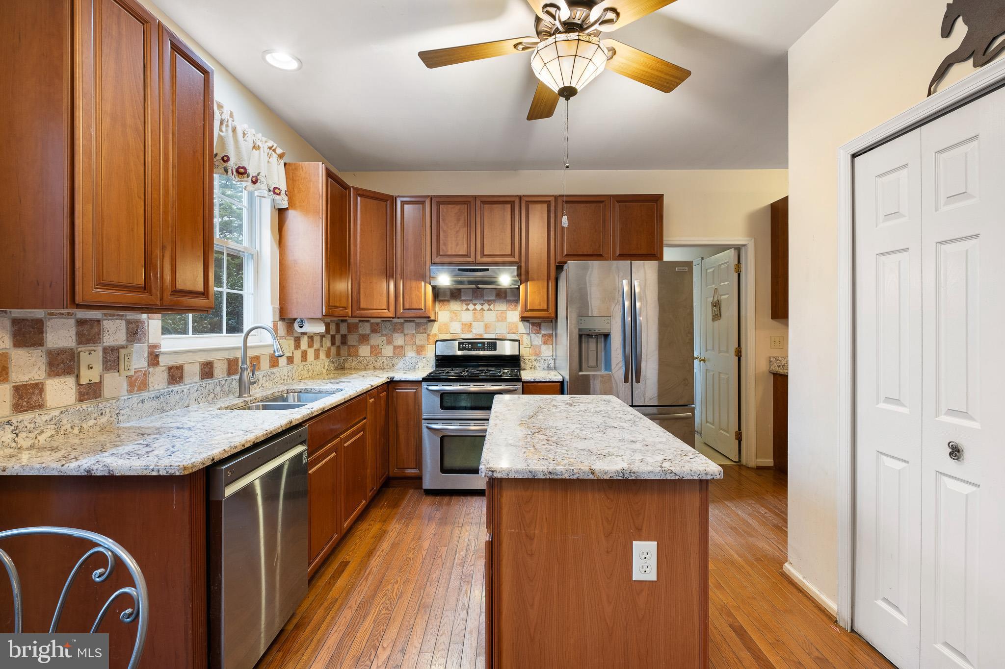 224 West Old Squaw Road Middletown, DE 19709 - Photo 14 of 43 a kitchen with stainless steel appliances granite countertop a sink refrigerator and cabinets