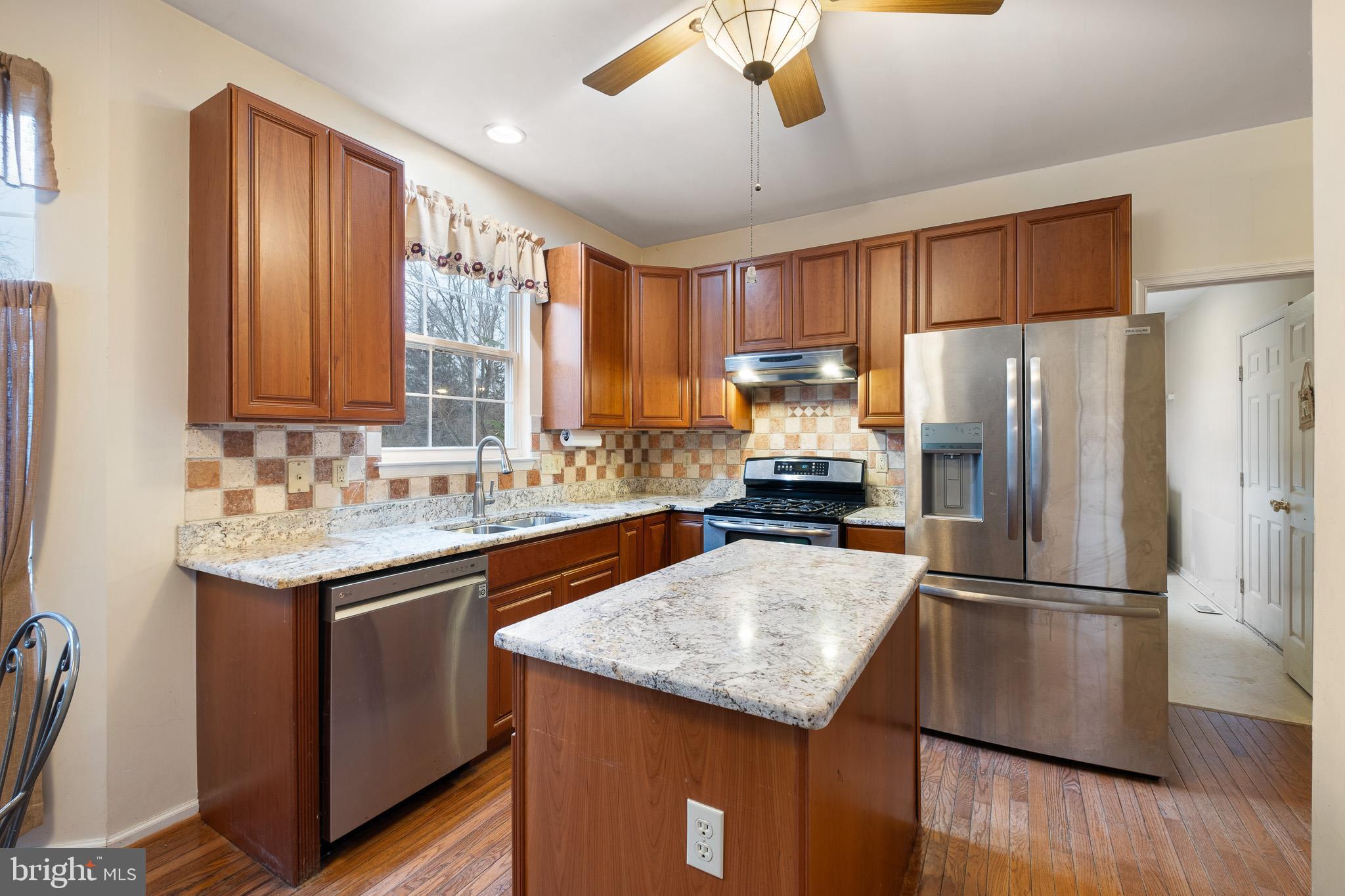 224 West Old Squaw Road Middletown, DE 19709 - Photo 15 of 43 a kitchen with stainless steel appliances granite countertop a sink refrigerator and microwave