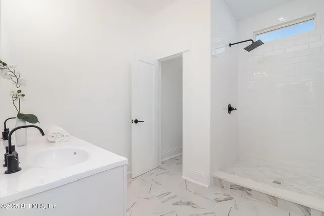a bathroom with a sink and shower